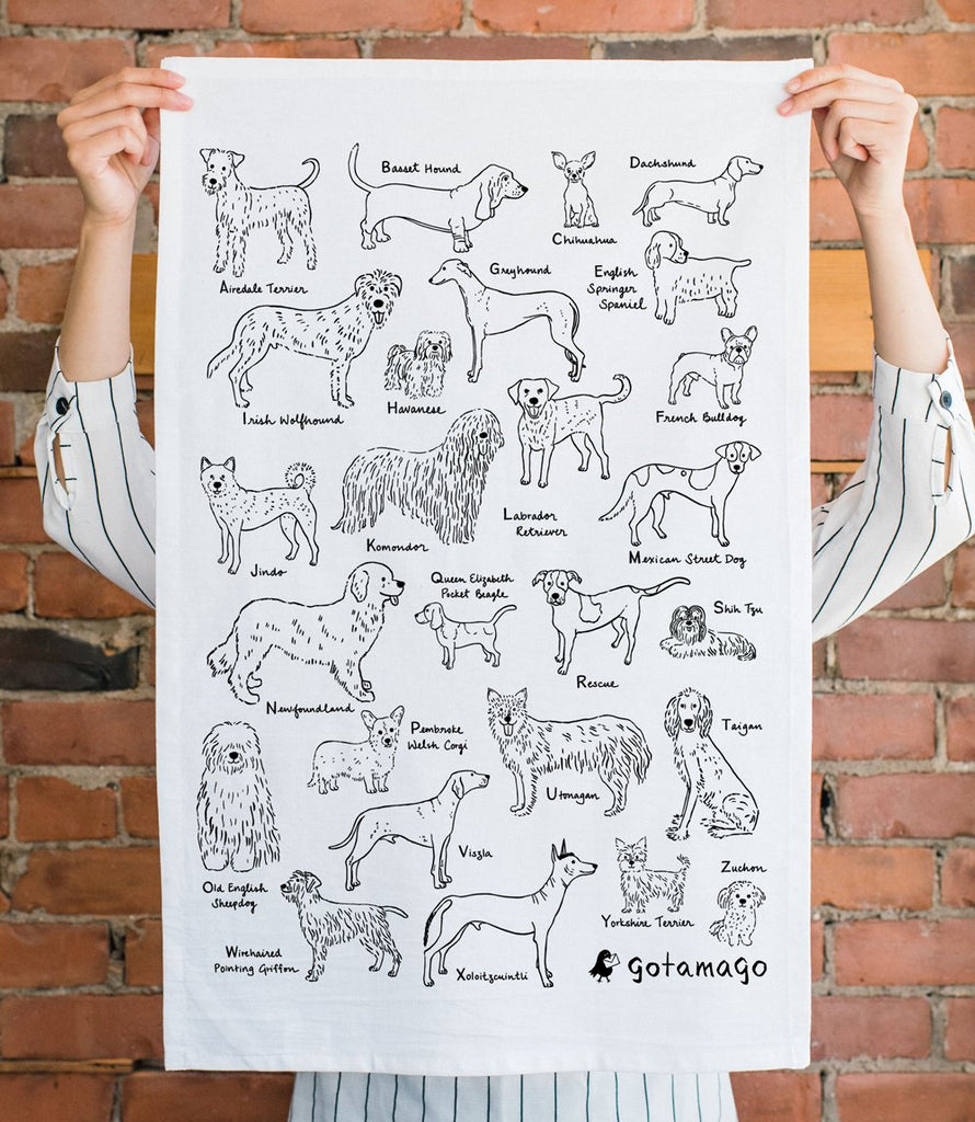 White cotton tea towel featuring 26 line drawings of dogs, one for each letter of the alphabet.