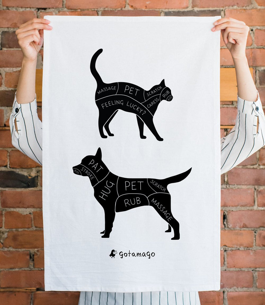 White cotton tea towel with black silhouettes of cat and dog including instructions on how and where to pet them.